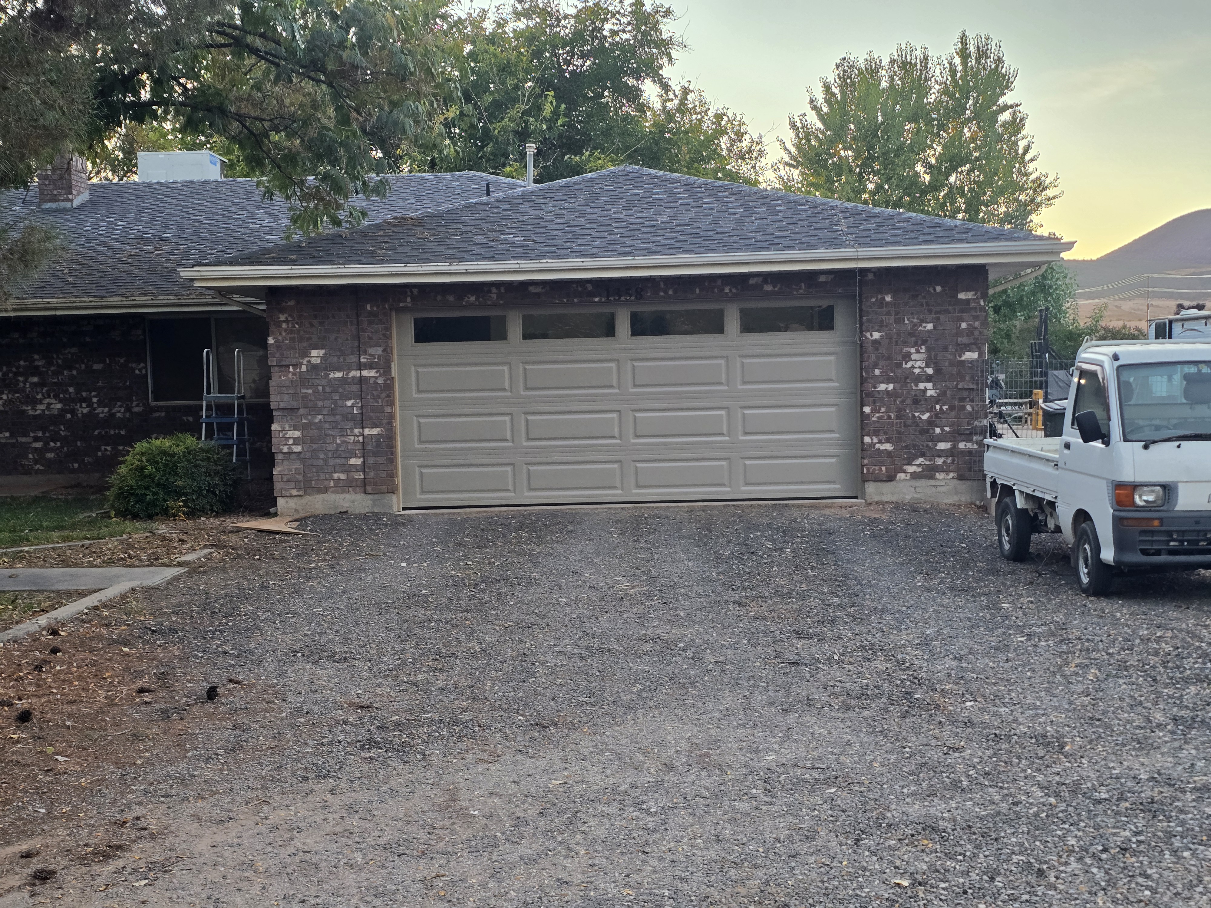 Completed garage door replacement on a brick ranch home