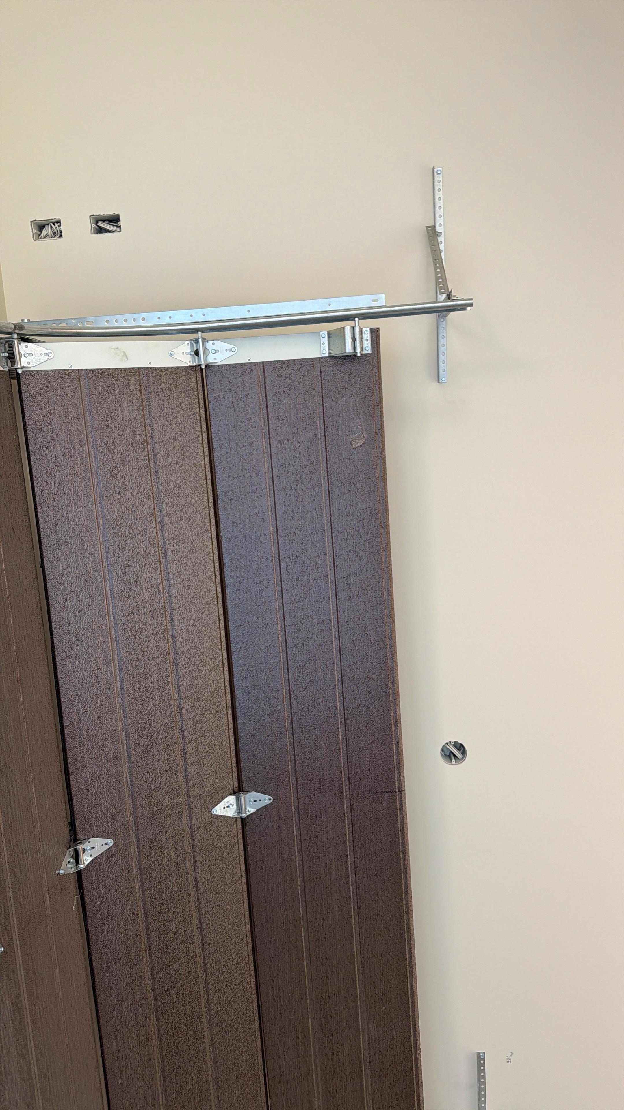 Close-up of garage door hardware installation work