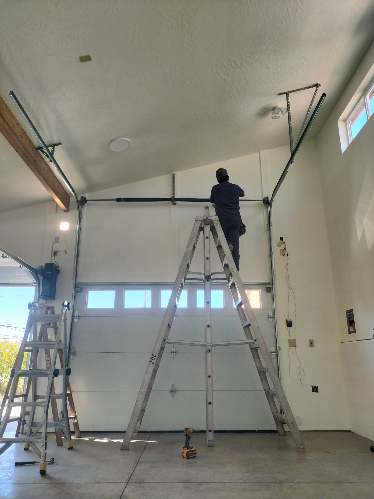 High Desert Garage Door technician installing a torsion spring